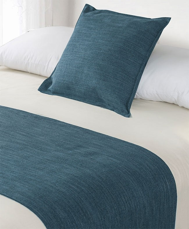 blue hotel bed cushion and bed runner