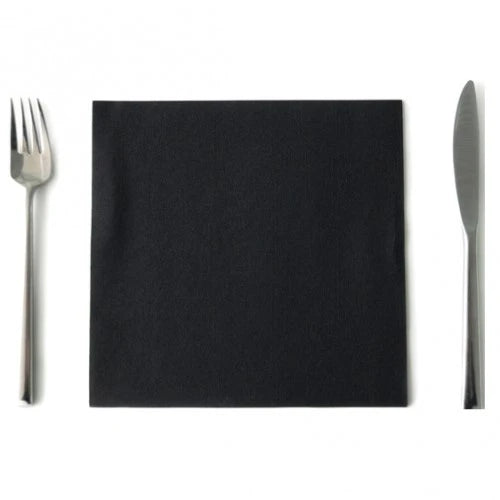 Black square napkin placed between a stainless steel fork and knife on a white background
