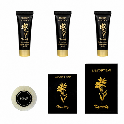 Tigerlily Opulence hotel guests' toiletry and travel set with shampoo, conditioner, body wash, shower cap, soap, and sanitary bag.