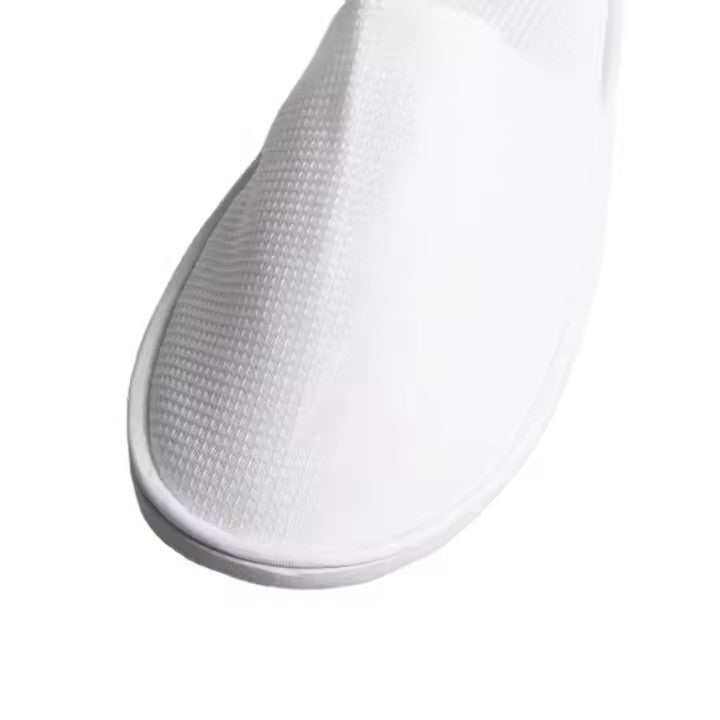 Pair of white open-toe men’s slippers with cushioned sole, suitable for hotel or spa use.