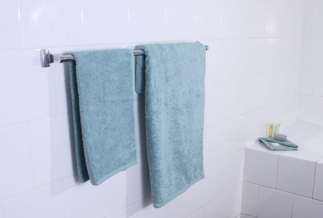 tack of frost-colored ultra towels neatly folded, showcasing soft and plush texture