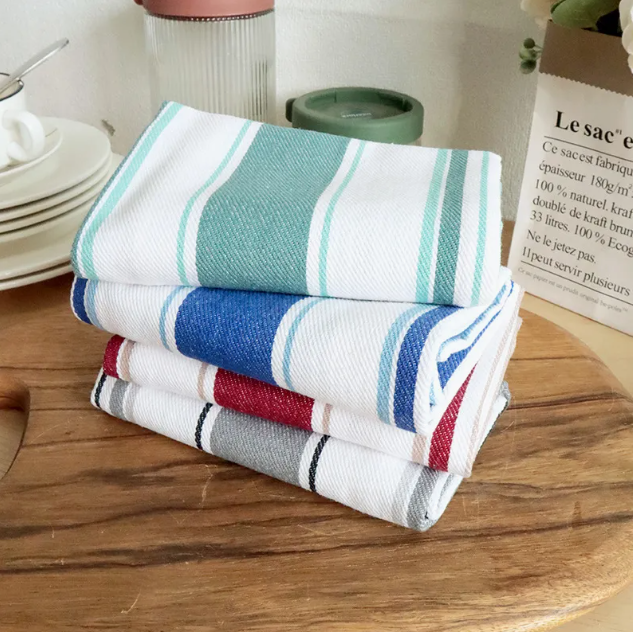 Simple white cotton tea towel folded neatly, ideal for kitchen use and drying dishes