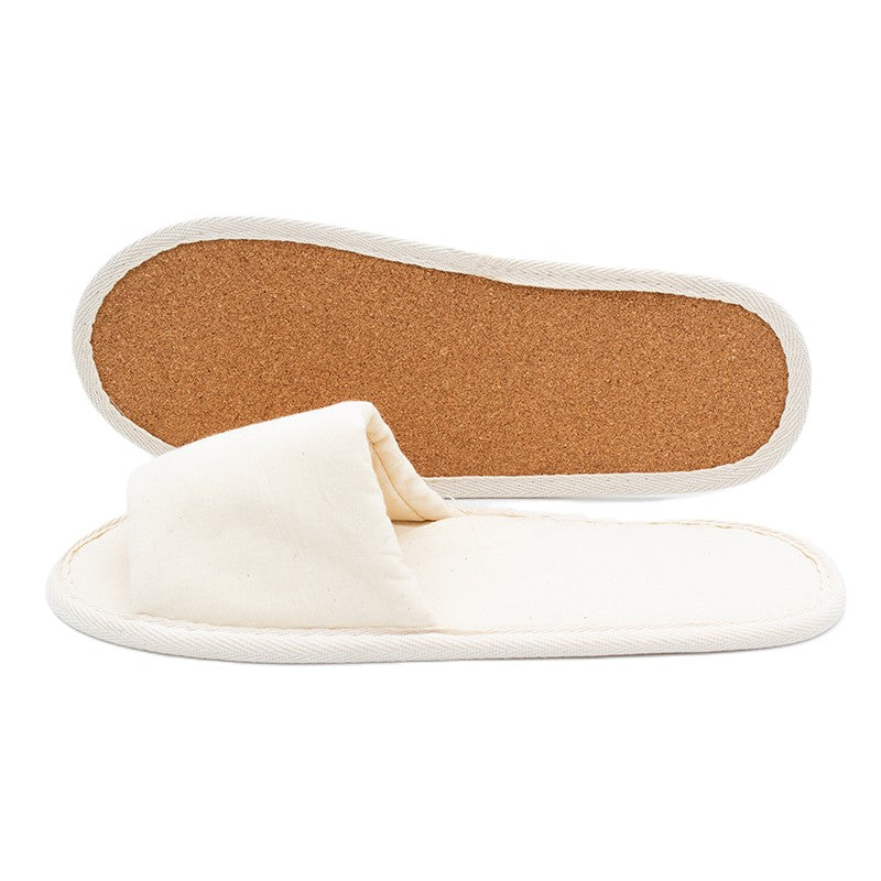 Beige open-toe fabric slippers, one showing the cork sole and the other laid flat to display the upper.