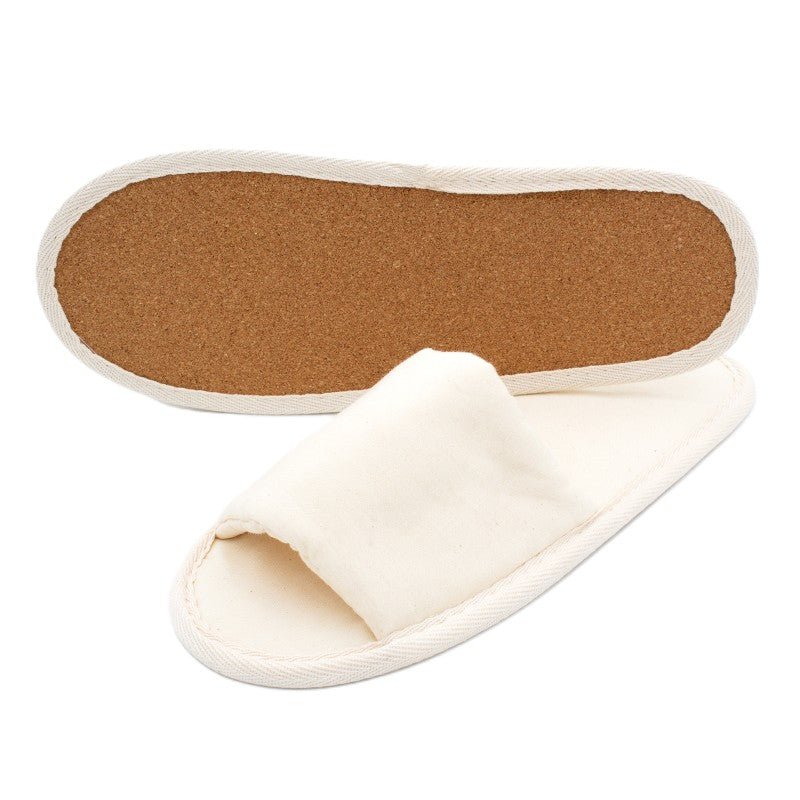 Pair of beige open-toe fabric slippers, one showing cork sole and the other displaying the upper part
