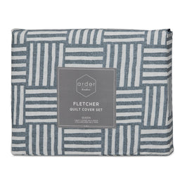 Packaged Ardor Boudoir Fletcher quilt cover set in blue and white geometric pattern for a queen bed