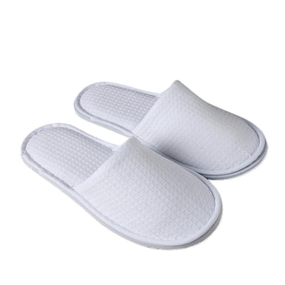 Large white men’s waffle slippers with open toe and textured fabric, designed for hotel or spa use.