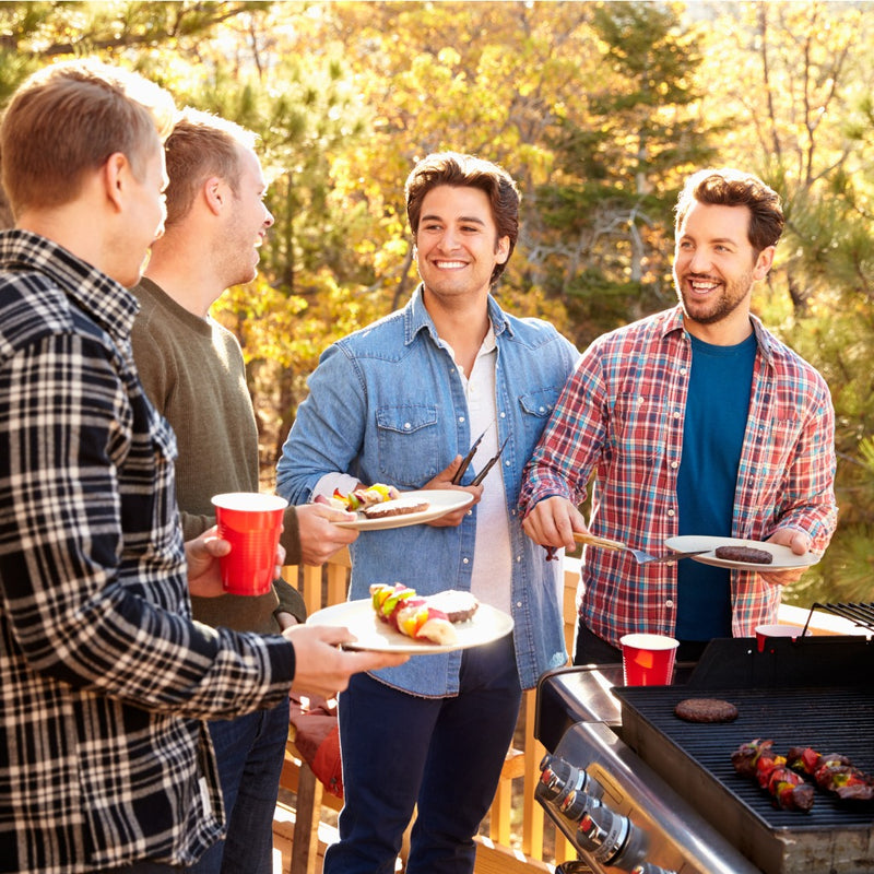 Guys having a barbeque with mates and cooking