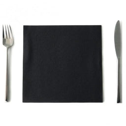 Black square napkin placed between a stainless steel fork and knife on a white background