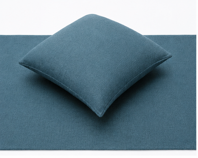 blue hotel bed cushion and runner