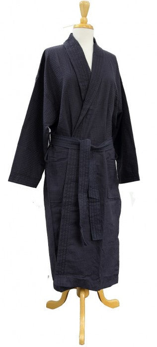 Full-length black waffle bathrobe with pockets and belt, displayed on a mannequin with wooden stand
