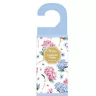 Blue floral scented door hanger air freshener with pink and blue flower illustrations on the packaging
