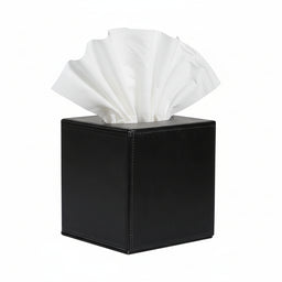 Black square tissue box with a white tissue protruding from the top against a plain background