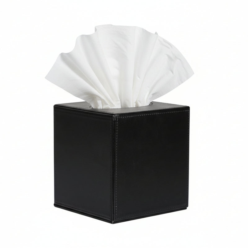 Black square tissue box with a white tissue protruding from the top against a plain background