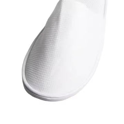 Pair of white open-toe men’s slippers with cushioned sole, suitable for hotel or spa use.