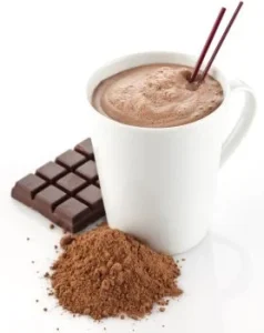 Cup of hot chocolate topped with frothy milk, served in a white mug on a saucer.