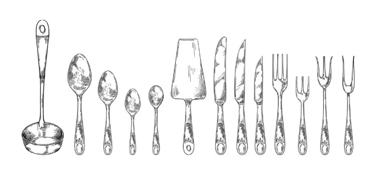 Assorted stainless steel cutlery set including forks, knives, and spoons with a polished finish