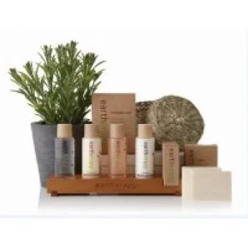 Ancient Earth toiletry bottles displayed with rosemary sprigs for a natural look.