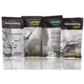 Purity brand sachets of dishwashing liquid, dishwashing powder, laundry powder, and laundry liquid in assorted packaging.