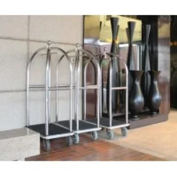 Three stainless steel hotel luggage trolleys with black platforms, parked in a lobby area.
