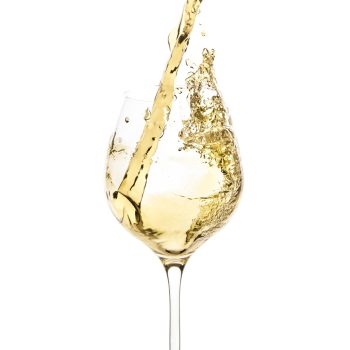 white-wine-being-poured-into-a-glass-and-splashing-out-picture-id462563873